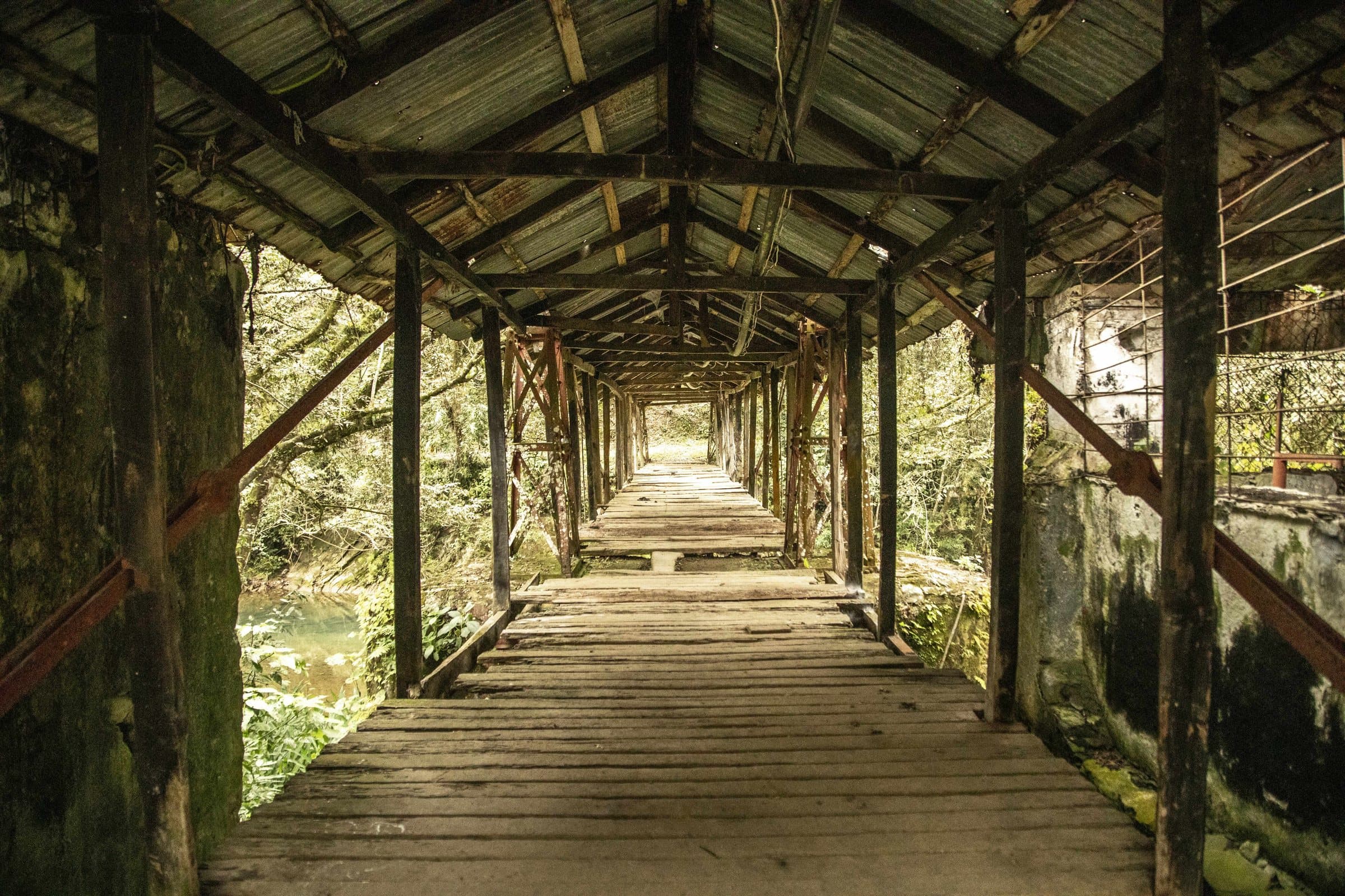 Un largo corredor techado de madera que atraviesa la finca.